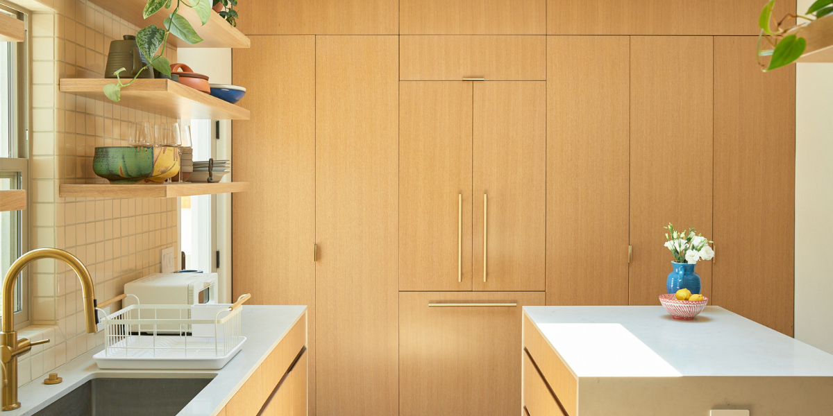 a kitchen and cabinets that is covered in wood veneer 